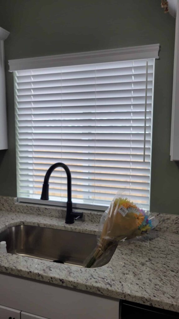 Blinds on kitchen window above sink